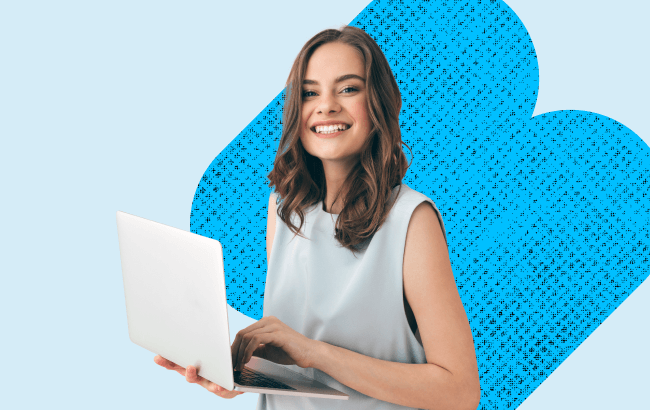 Gen Z woman smiling and holding an open laptop
